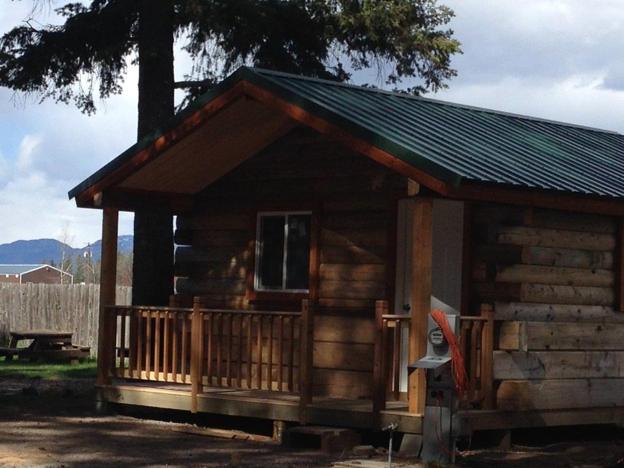 Side view of outside of Kintal cabin, including electric hookups.